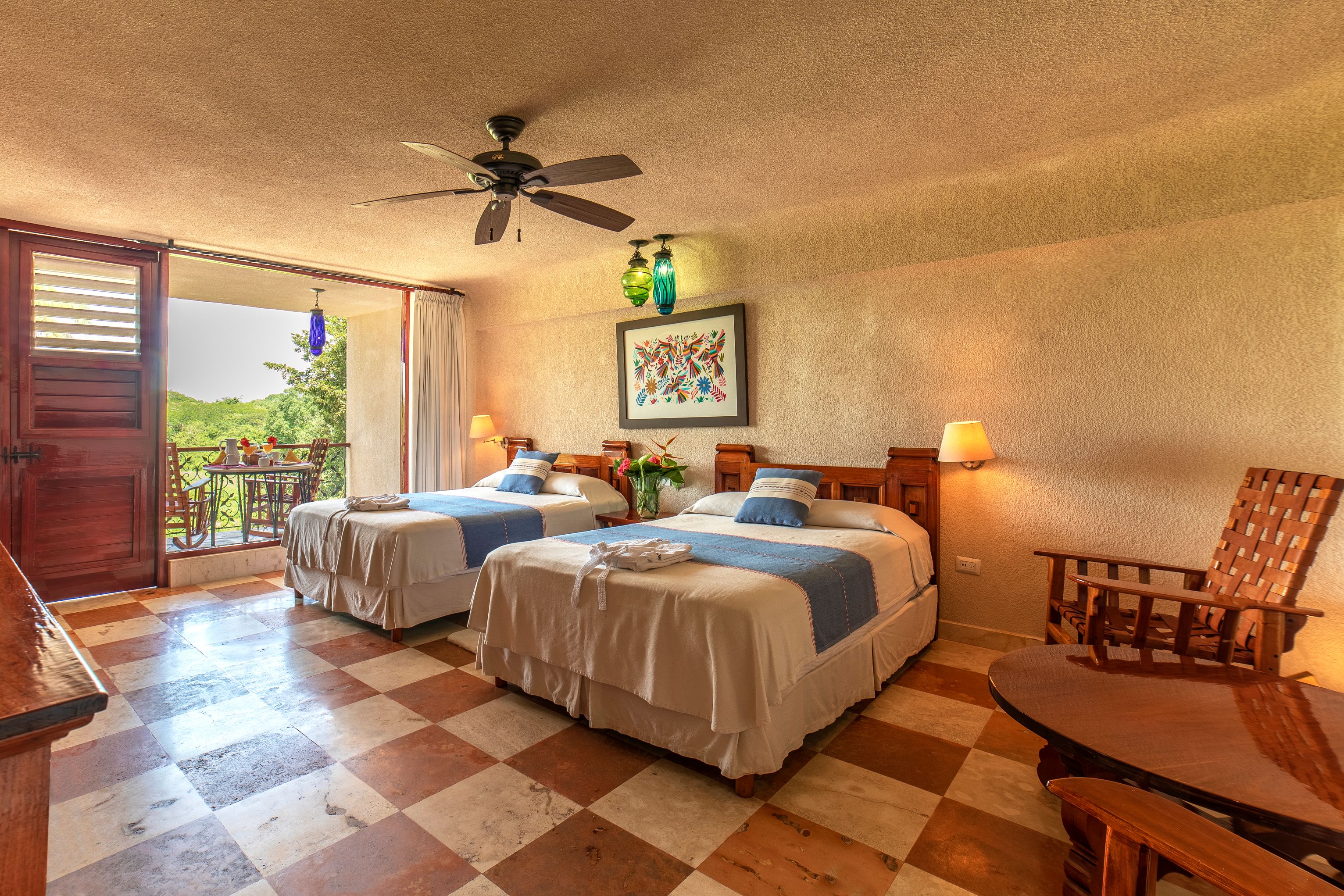 a room with two beds and a ceiling fan