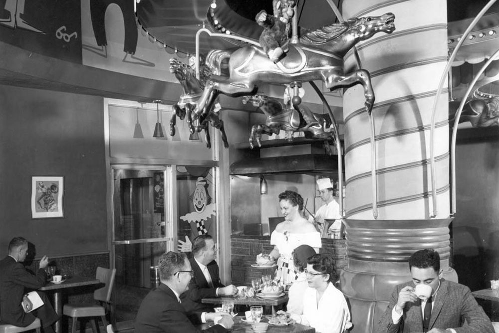 a group of people sitting at a table in a restaurant