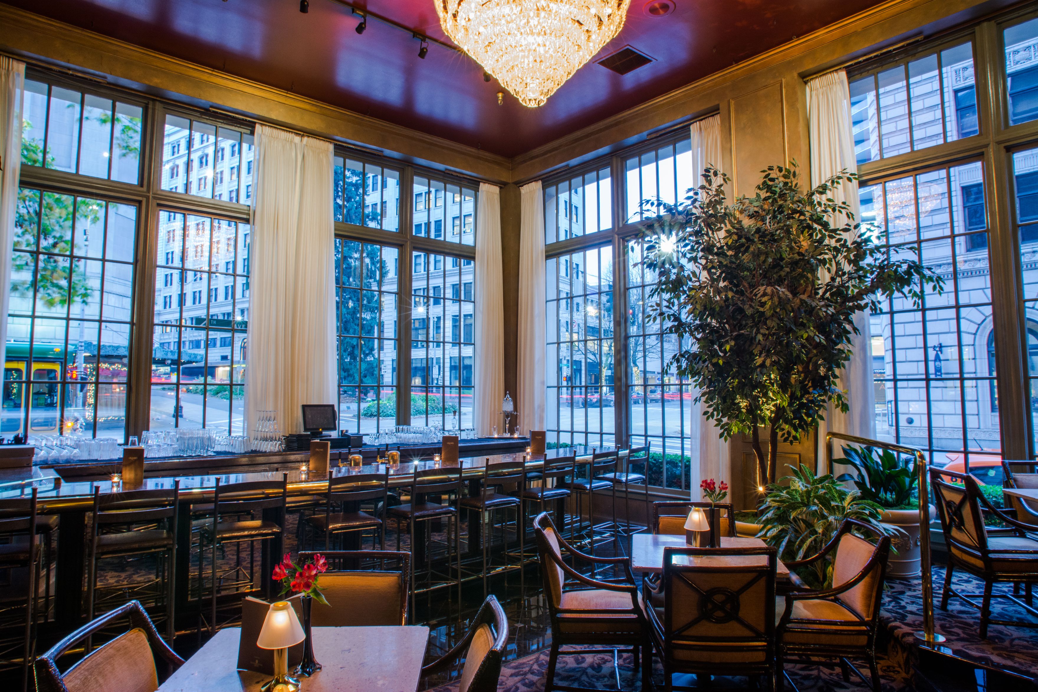 a room with tables and chairs and a chandelier