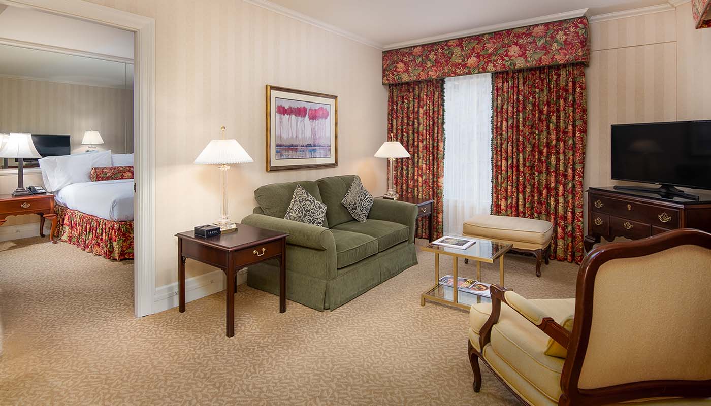 a living room with a green couch and a chair