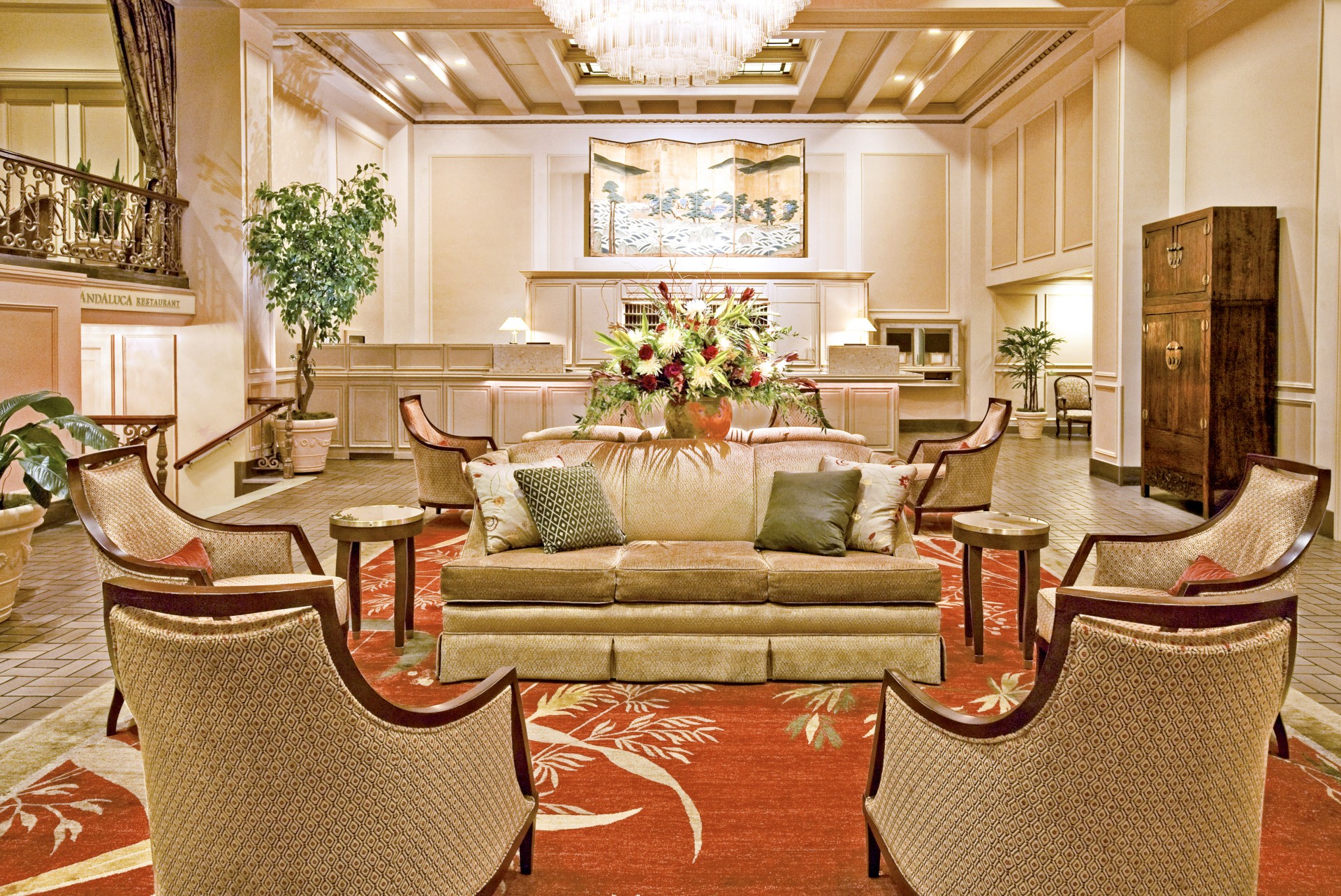 a room with a couch and chairs