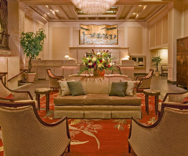 a room with a couch and chairs
