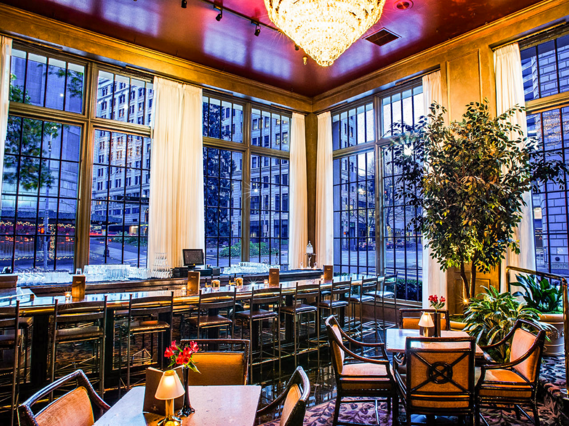 a room with tables and chairs and a chandelier