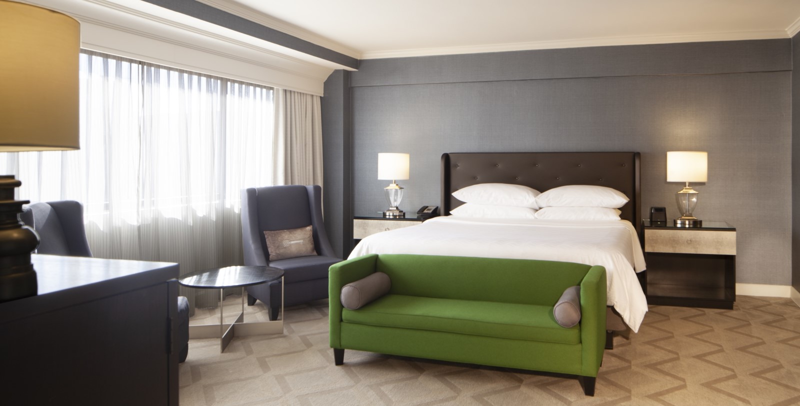 a room with a bed and a green couch