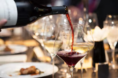 a wine being poured into a glass