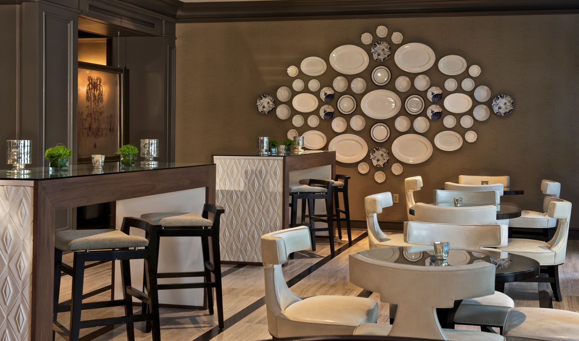 a room with white chairs and tables