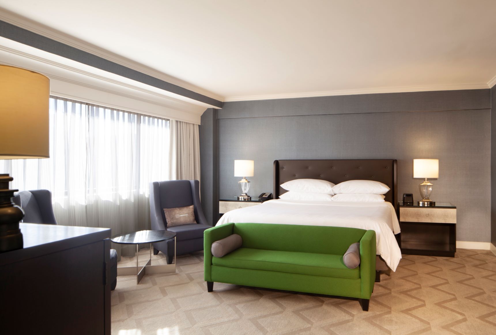 a room with a bed and a green couch