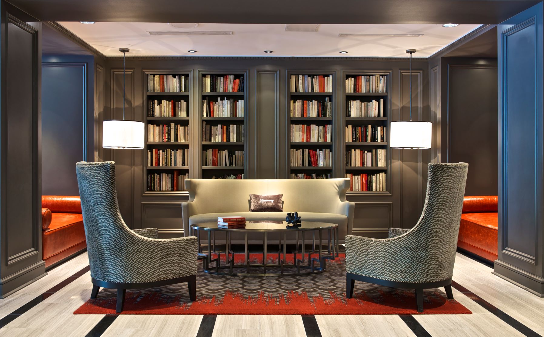 a room with a couch and a table and bookshelf