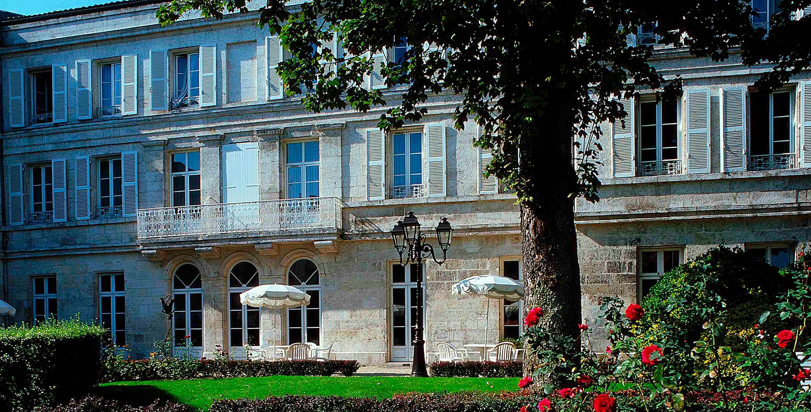a building with a lawn and umbrella