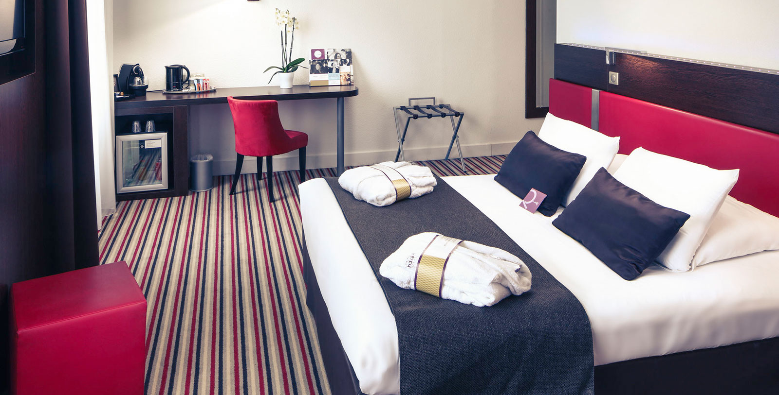 a hotel room with a bed and a desk