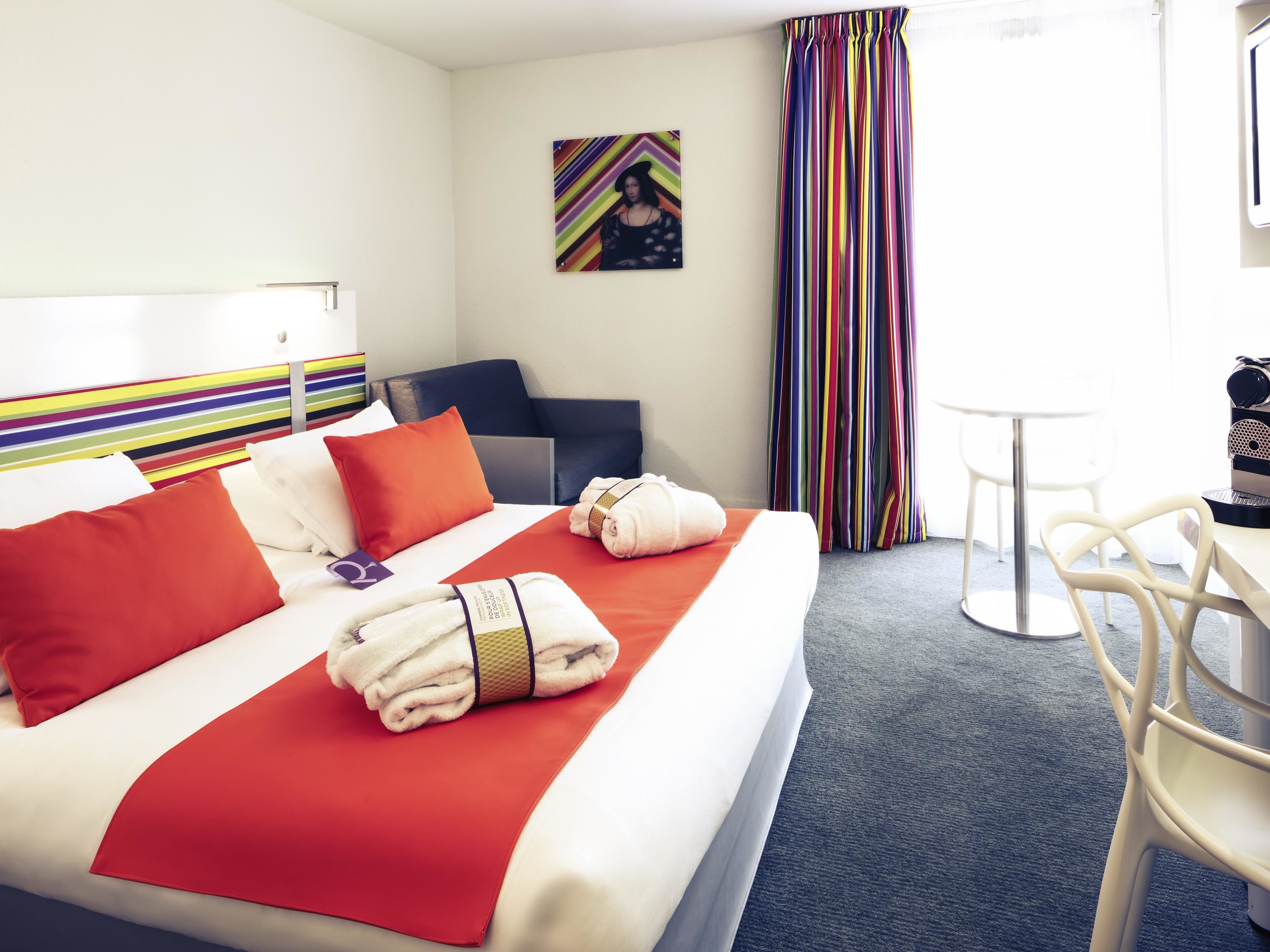 a hotel room with a bed and chairs