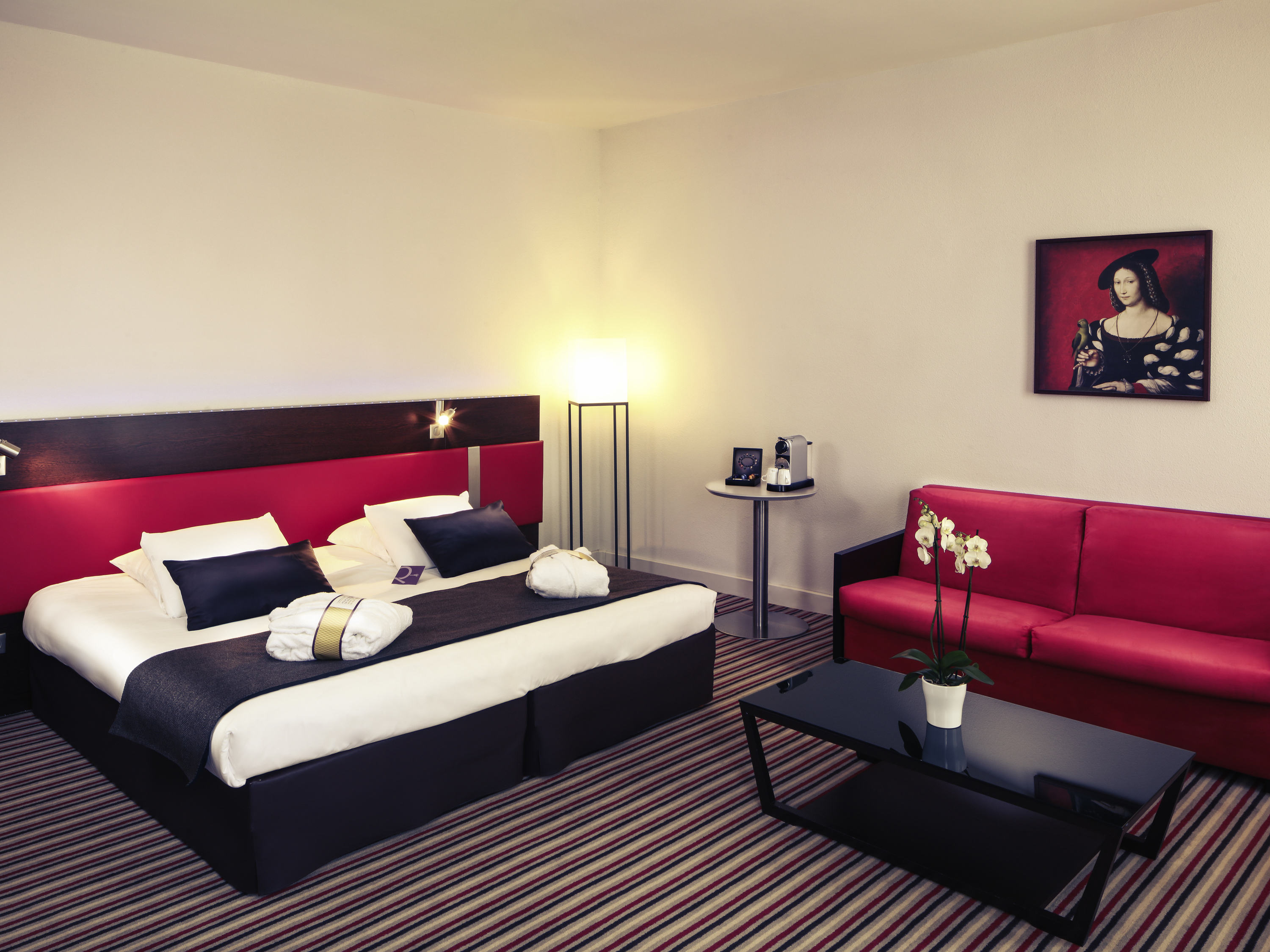 a room with two beds and a couch