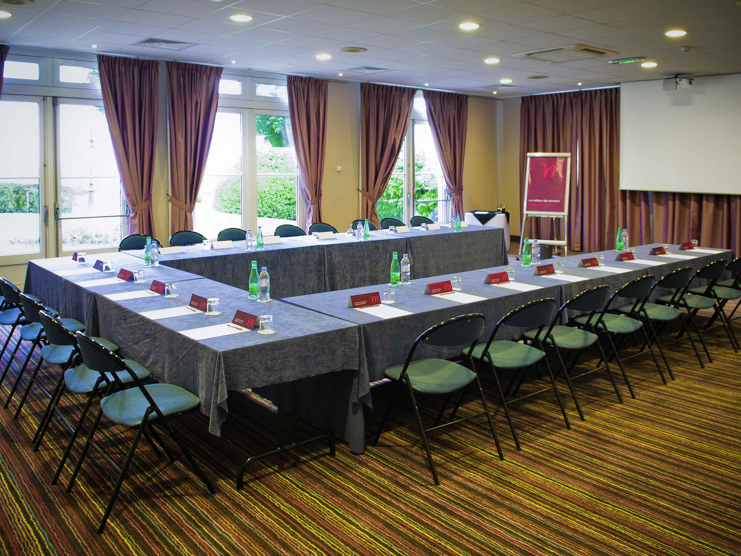 a long conference room with tables and chairs