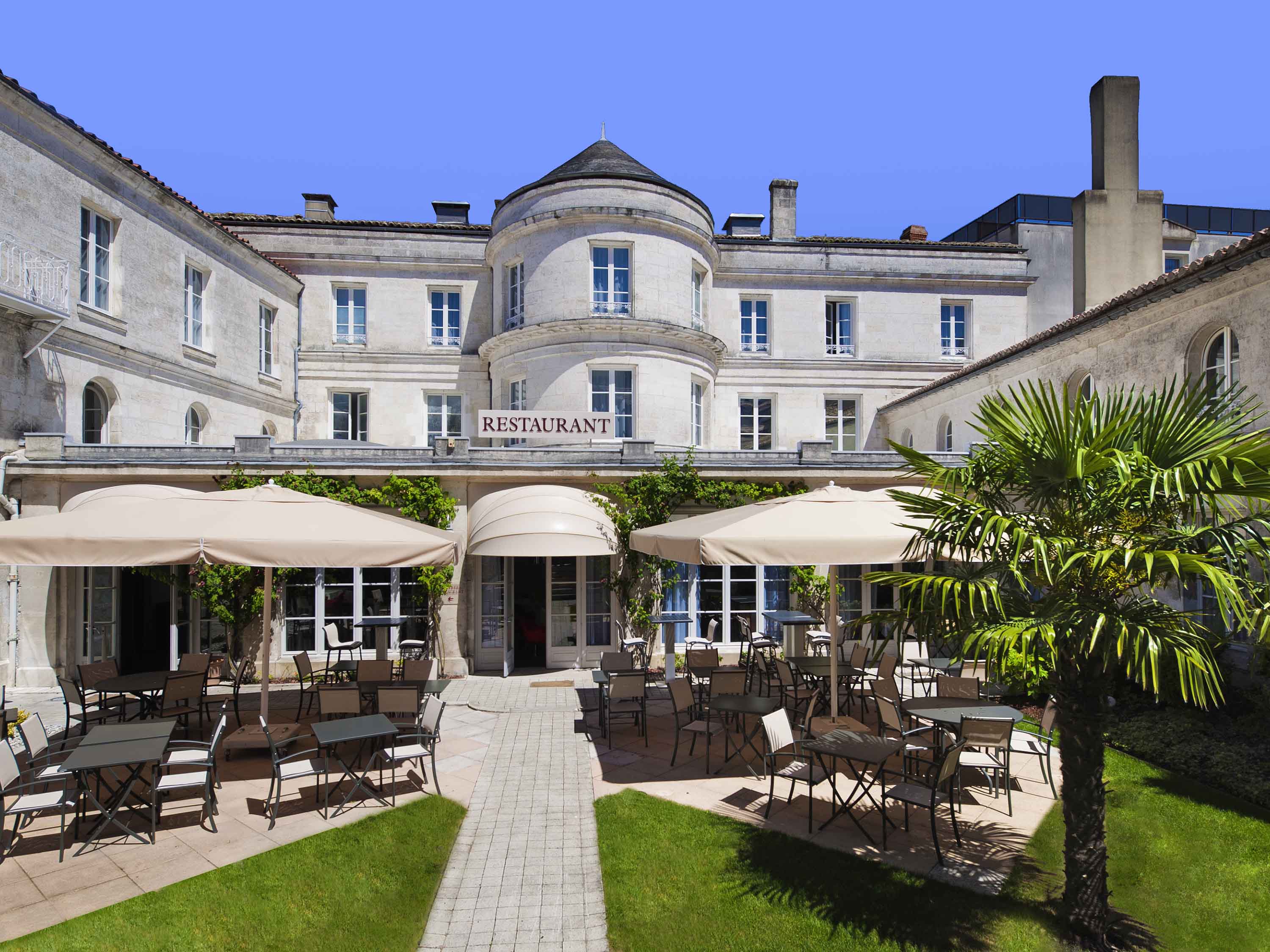 a building with tables and chairs outside