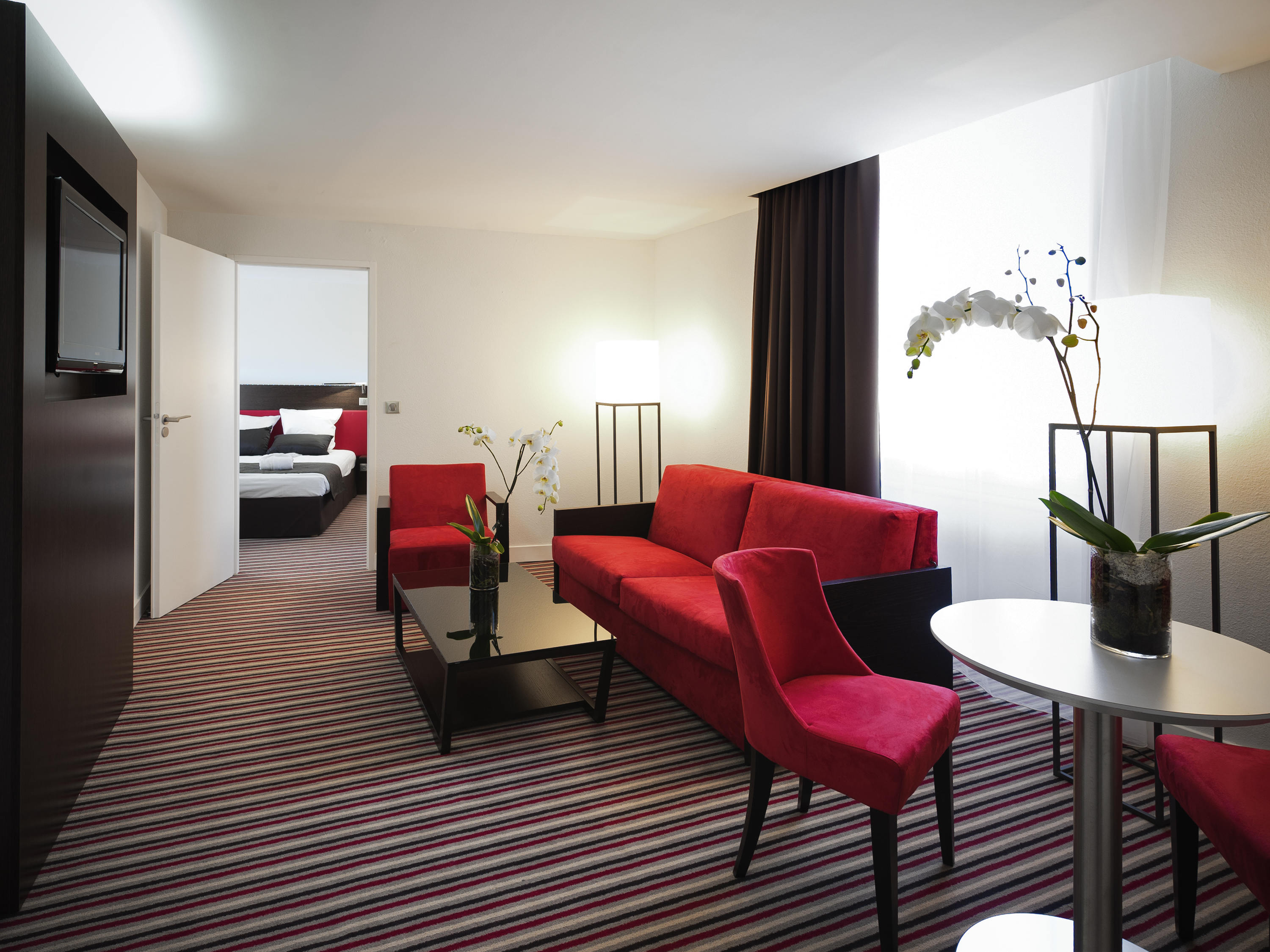 a room with a couch and chairs
