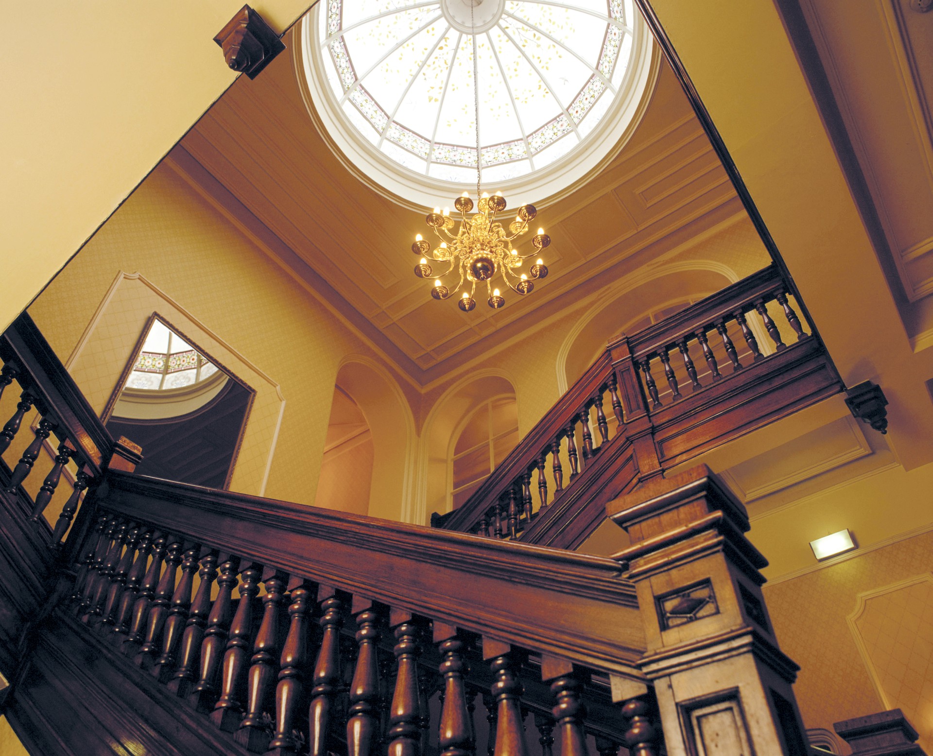 a staircase with a light fixture from the ceiling