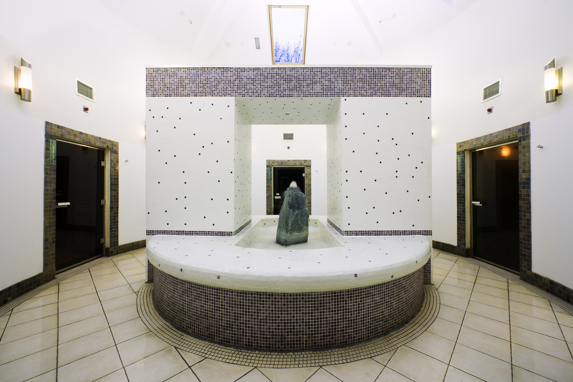 a room with a stone fountain