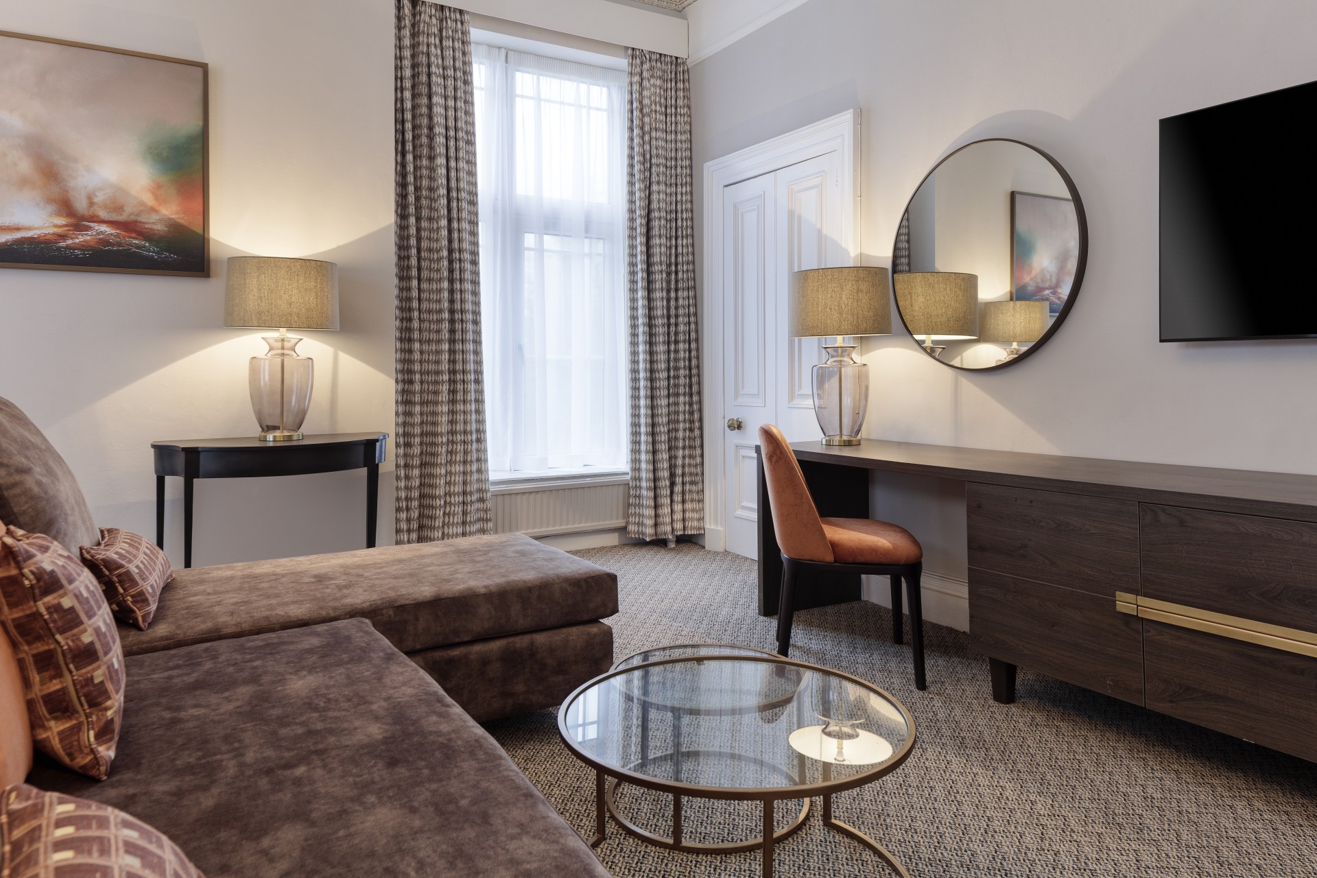 a room with a couch and a table and lamp
