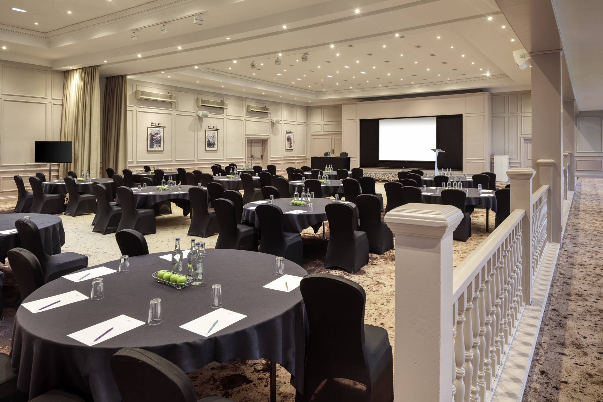 a room with round tables and chairs