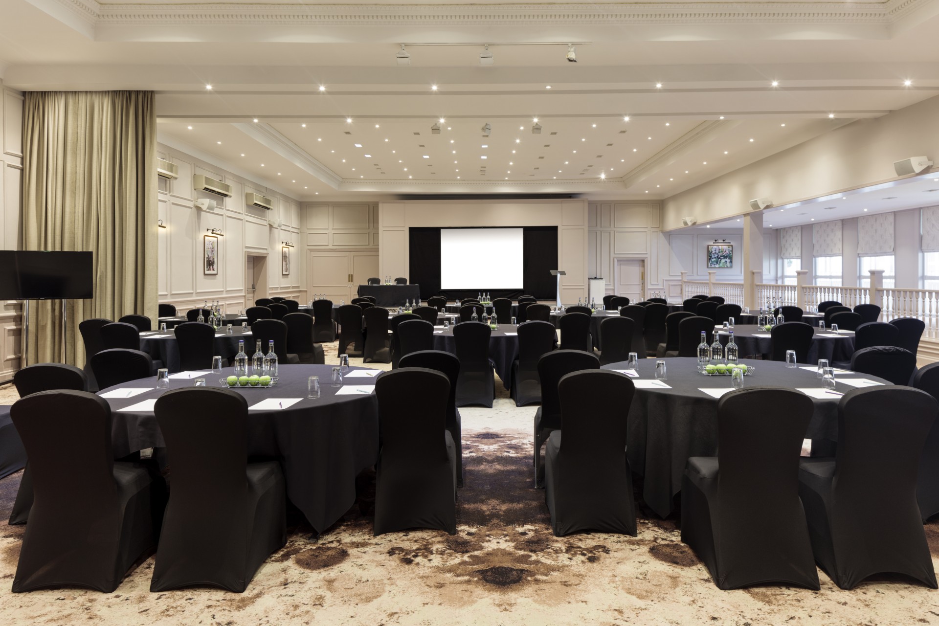 a large room with black chairs and tables