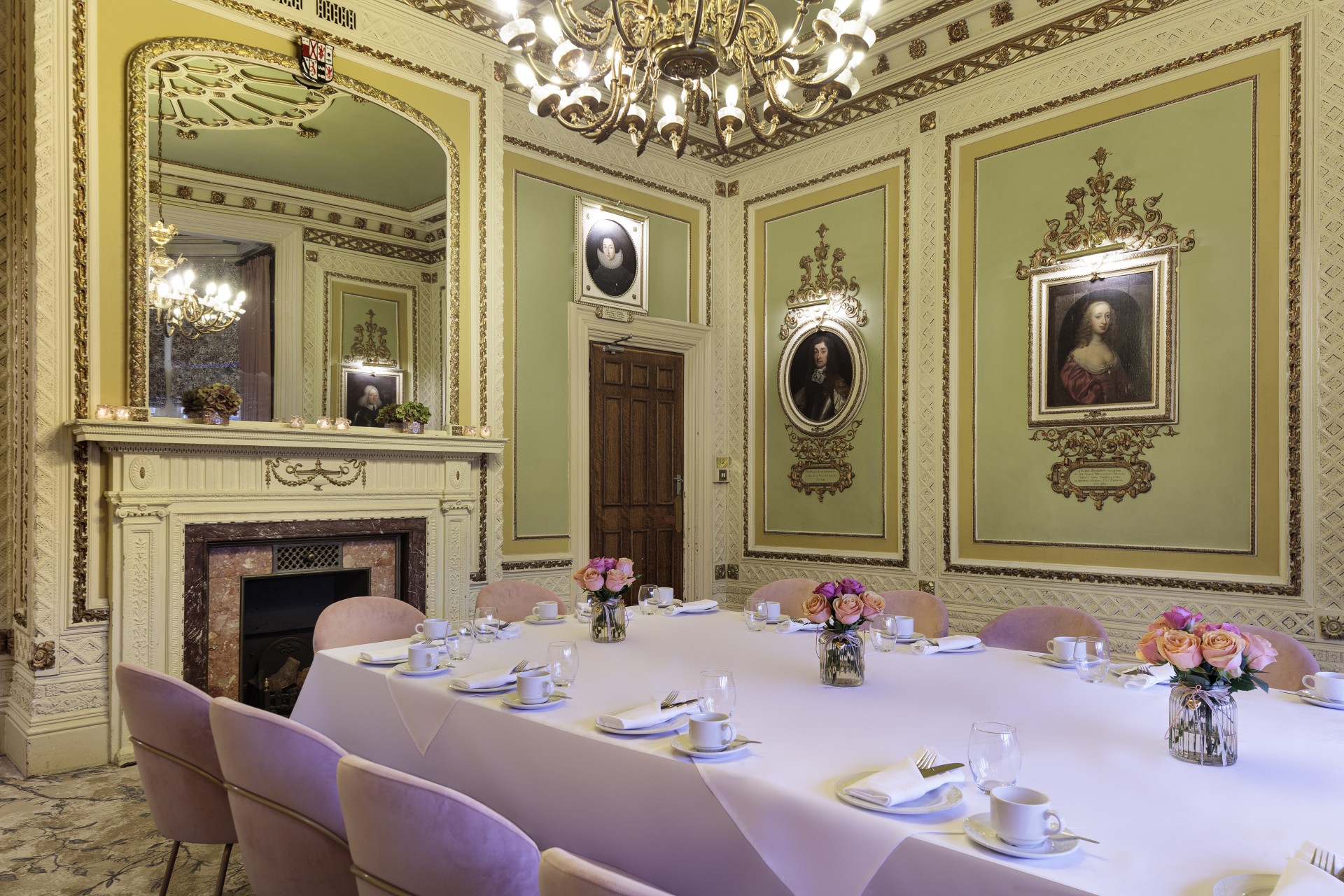 a room with a table set for a dinner party