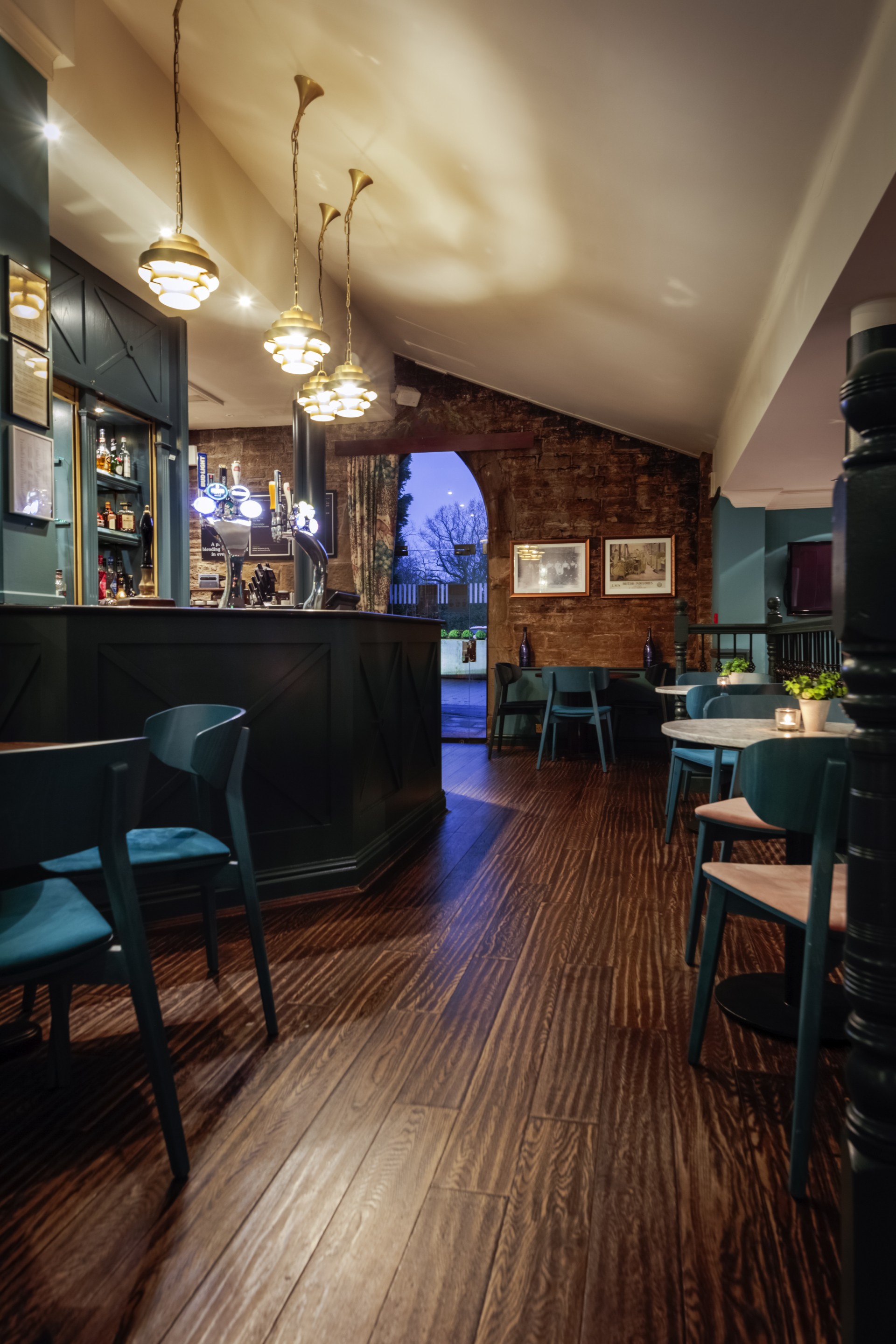a room with a bar and chairs