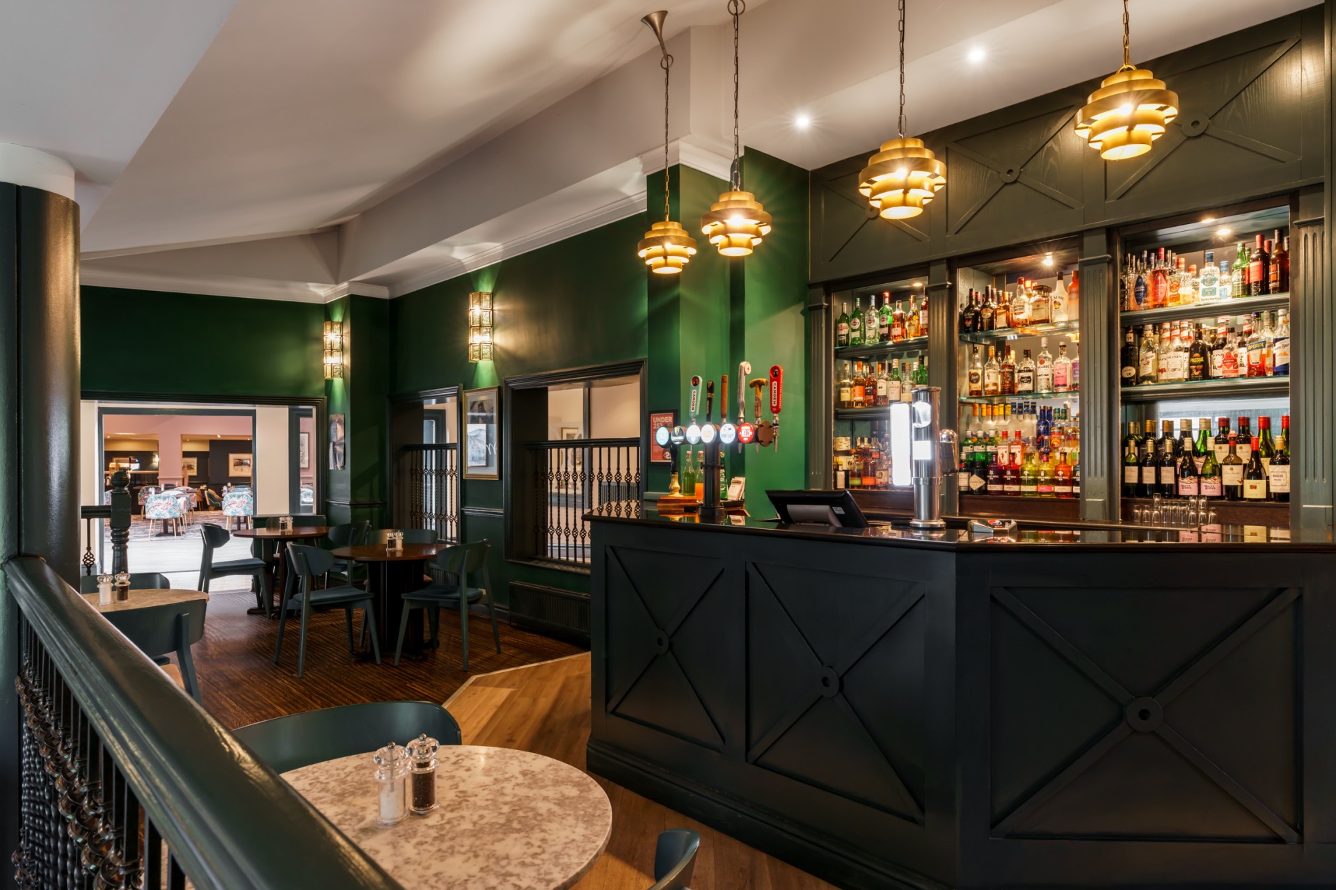 a bar with a green wall and a green counter
