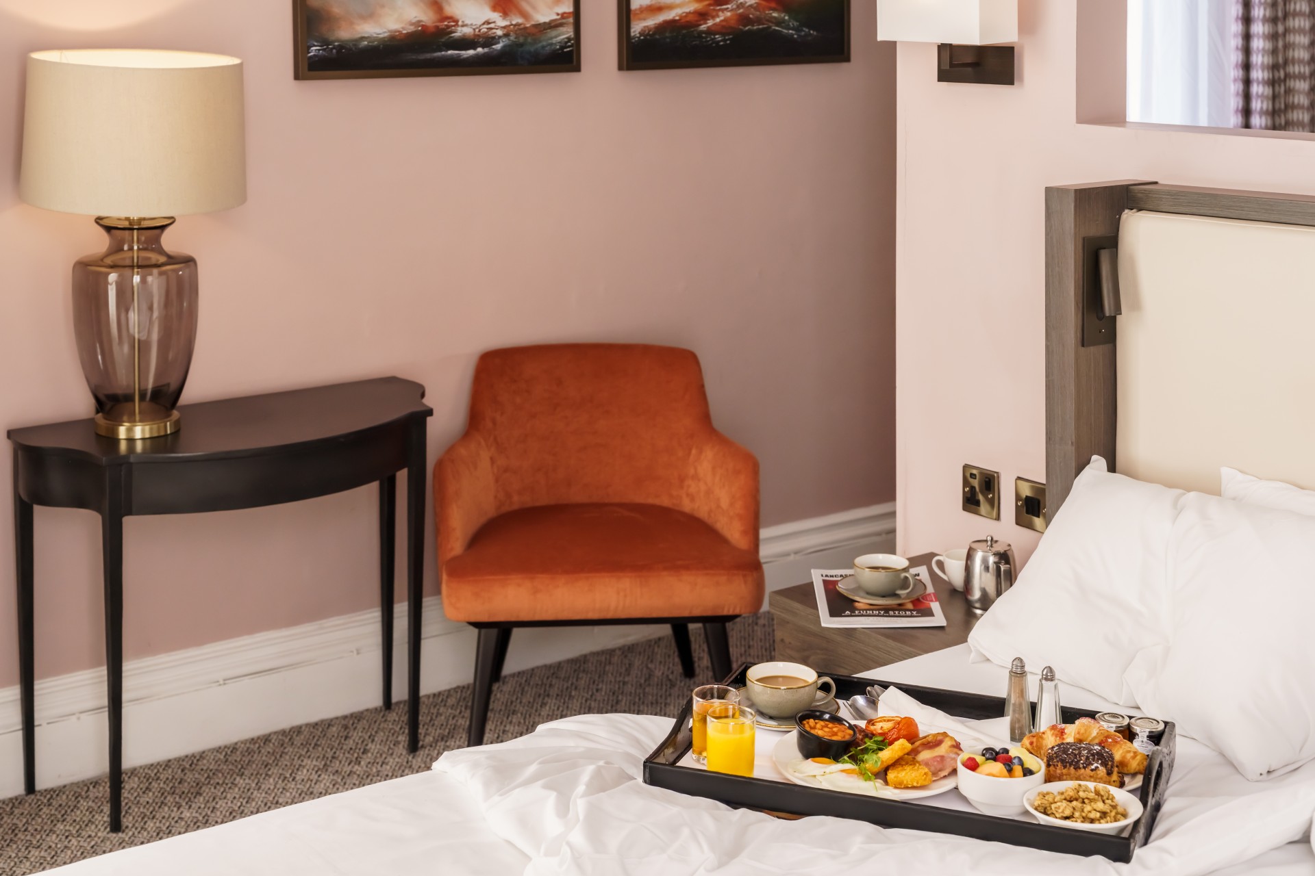 a tray of food on a bed