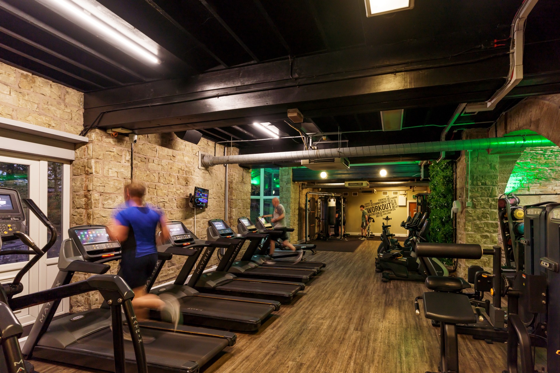 people running on treadmills in a gym