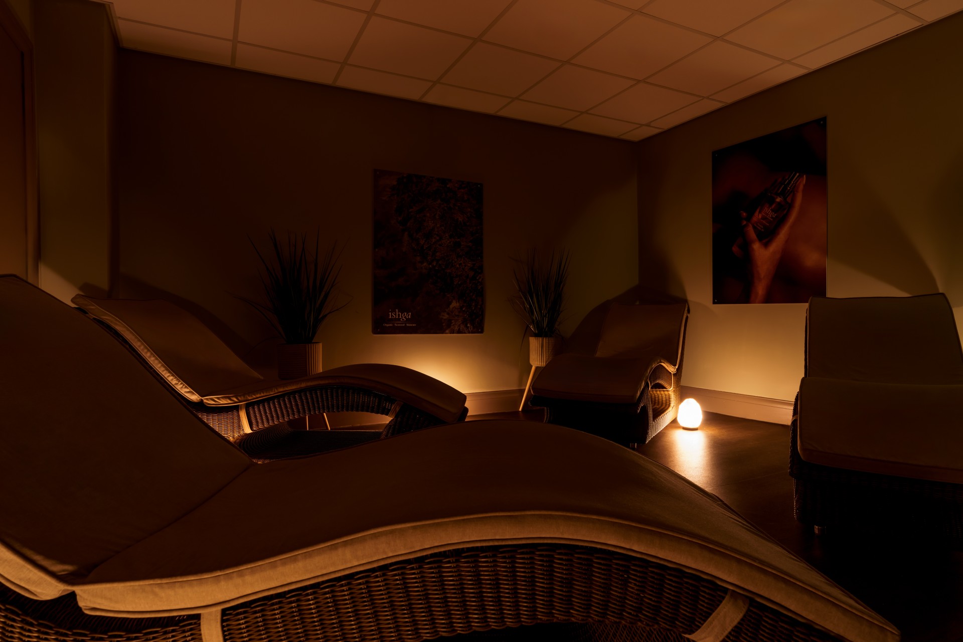 a room with chairs and a lamp