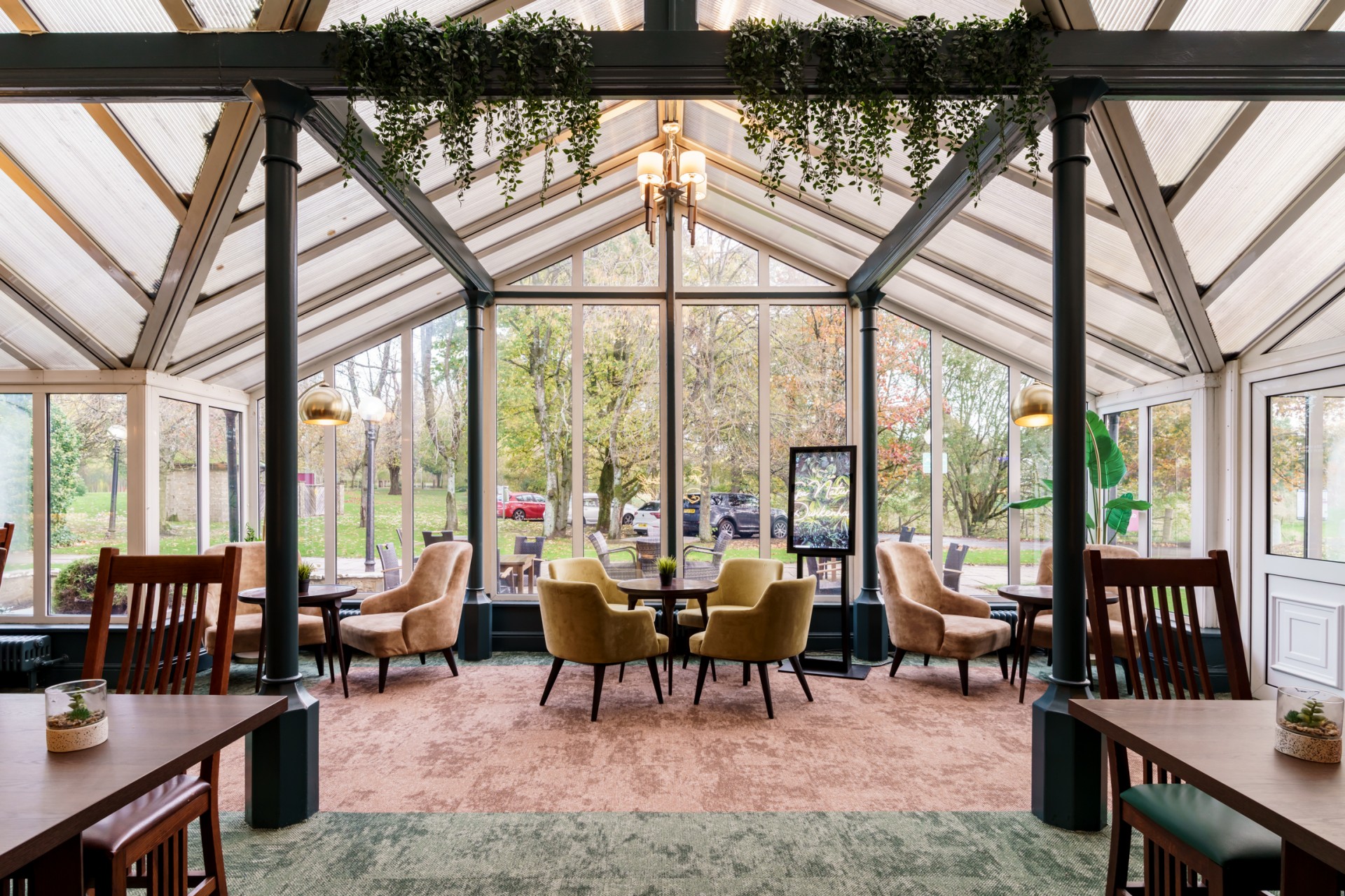 a room with a glass wall and tables and chairs
