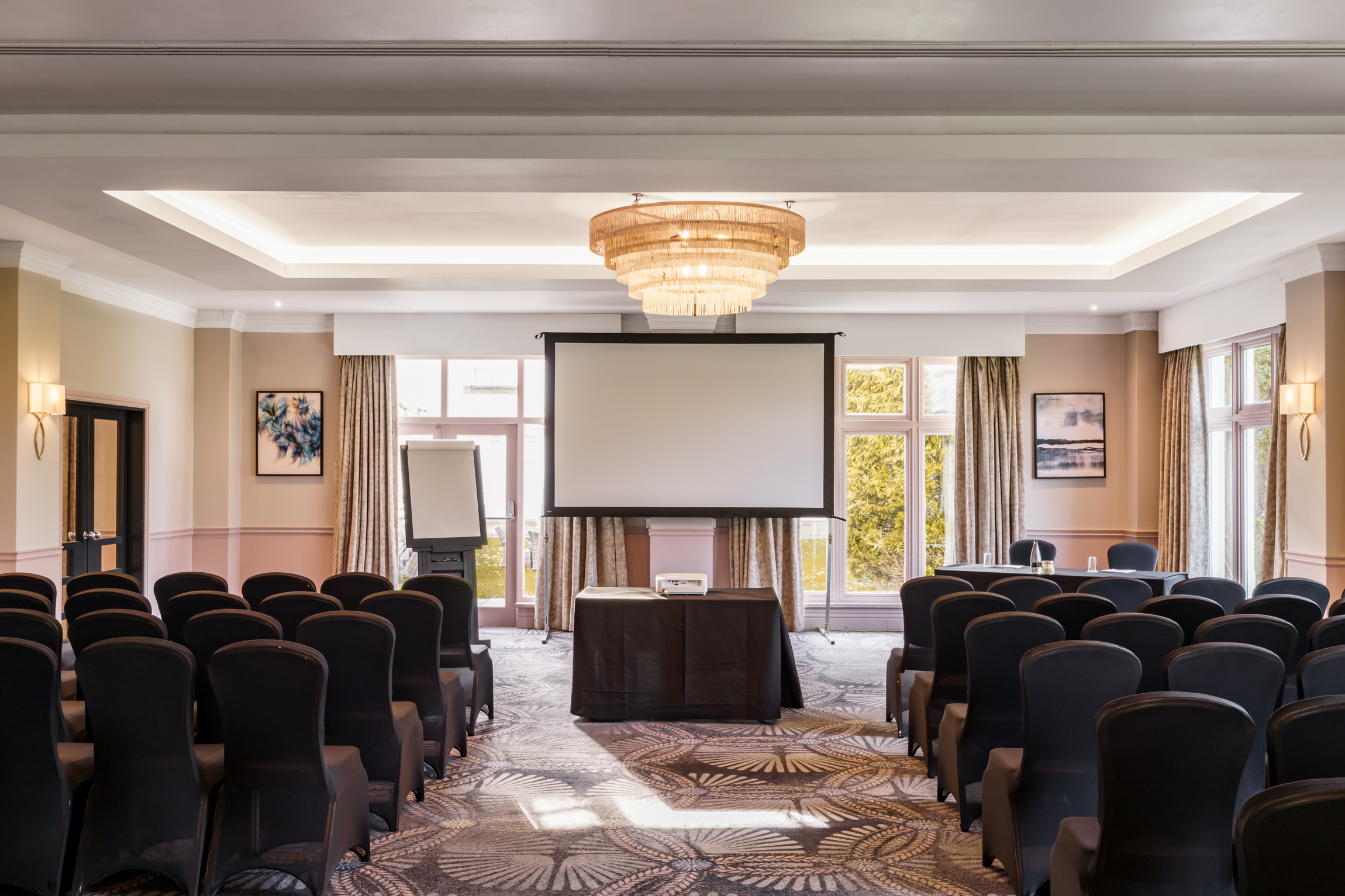 a room with chairs and a projector screen