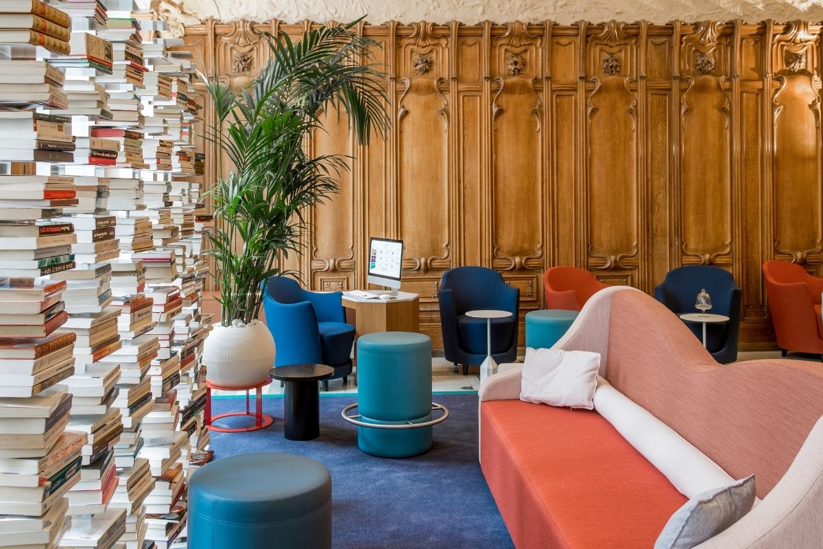 a room with a tall stack of books