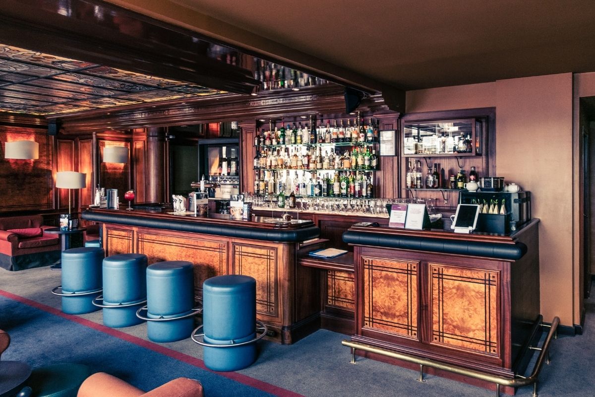 a bar with bottles and stools