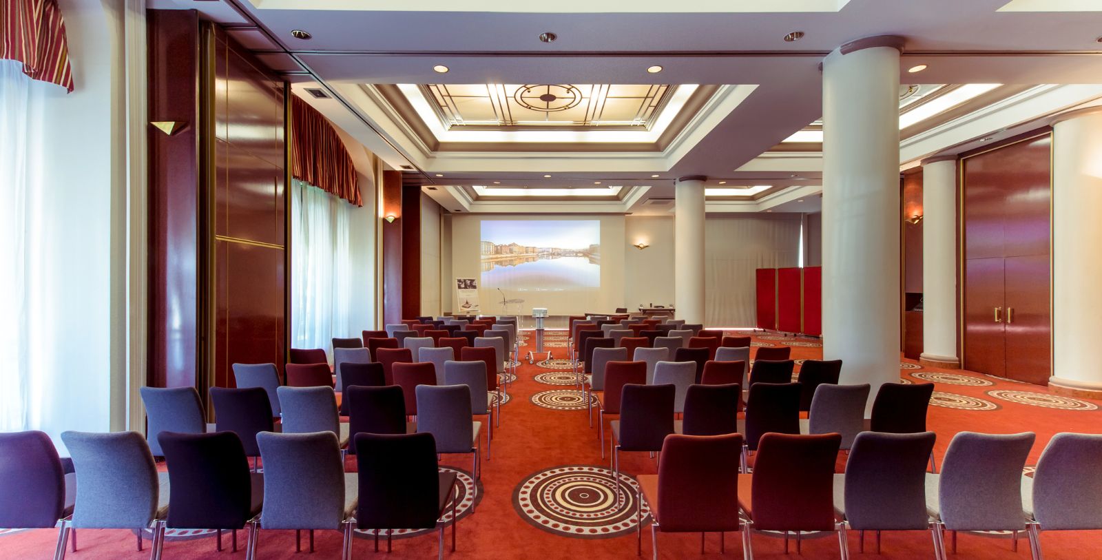 a room with chairs and a projector screen