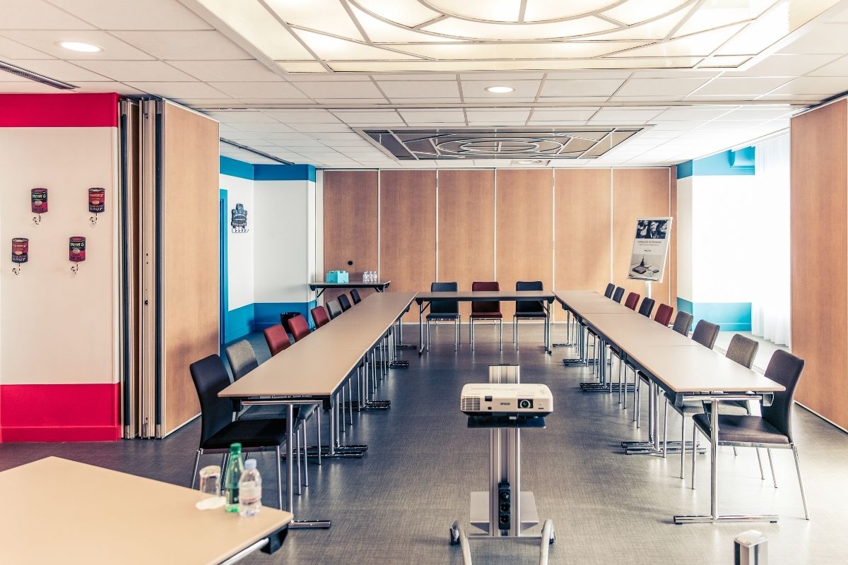 a room with long tables and chairs