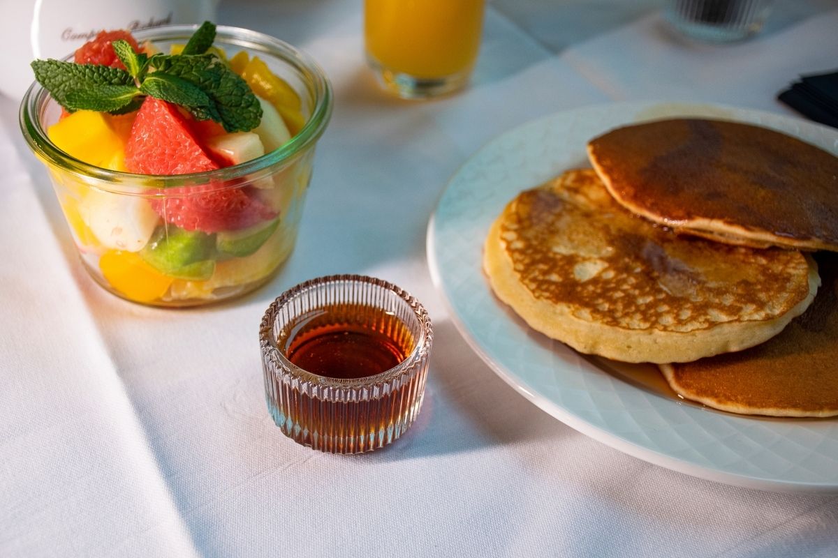 a plate of pancakes and fruit salad