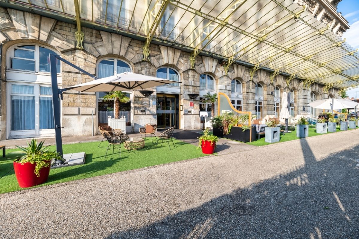 a patio area with chairs and umbrellas