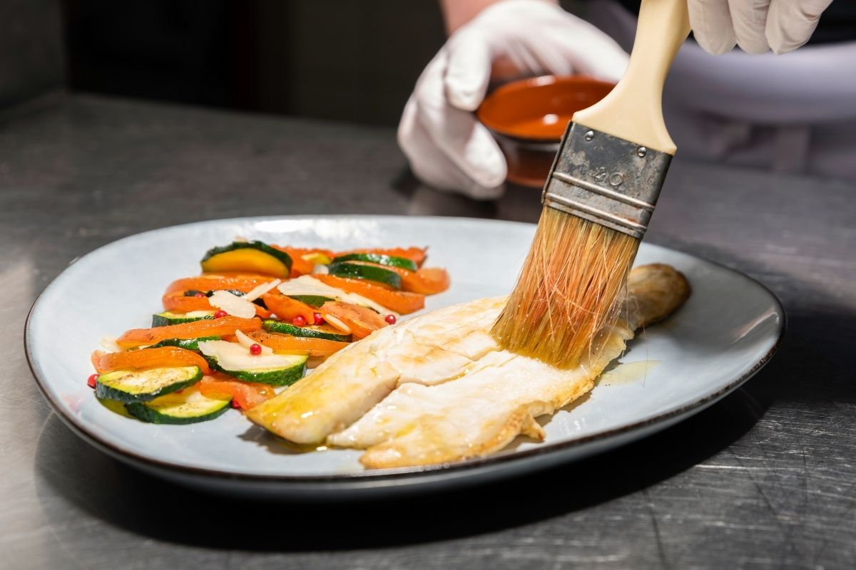 a person painting food on a plate