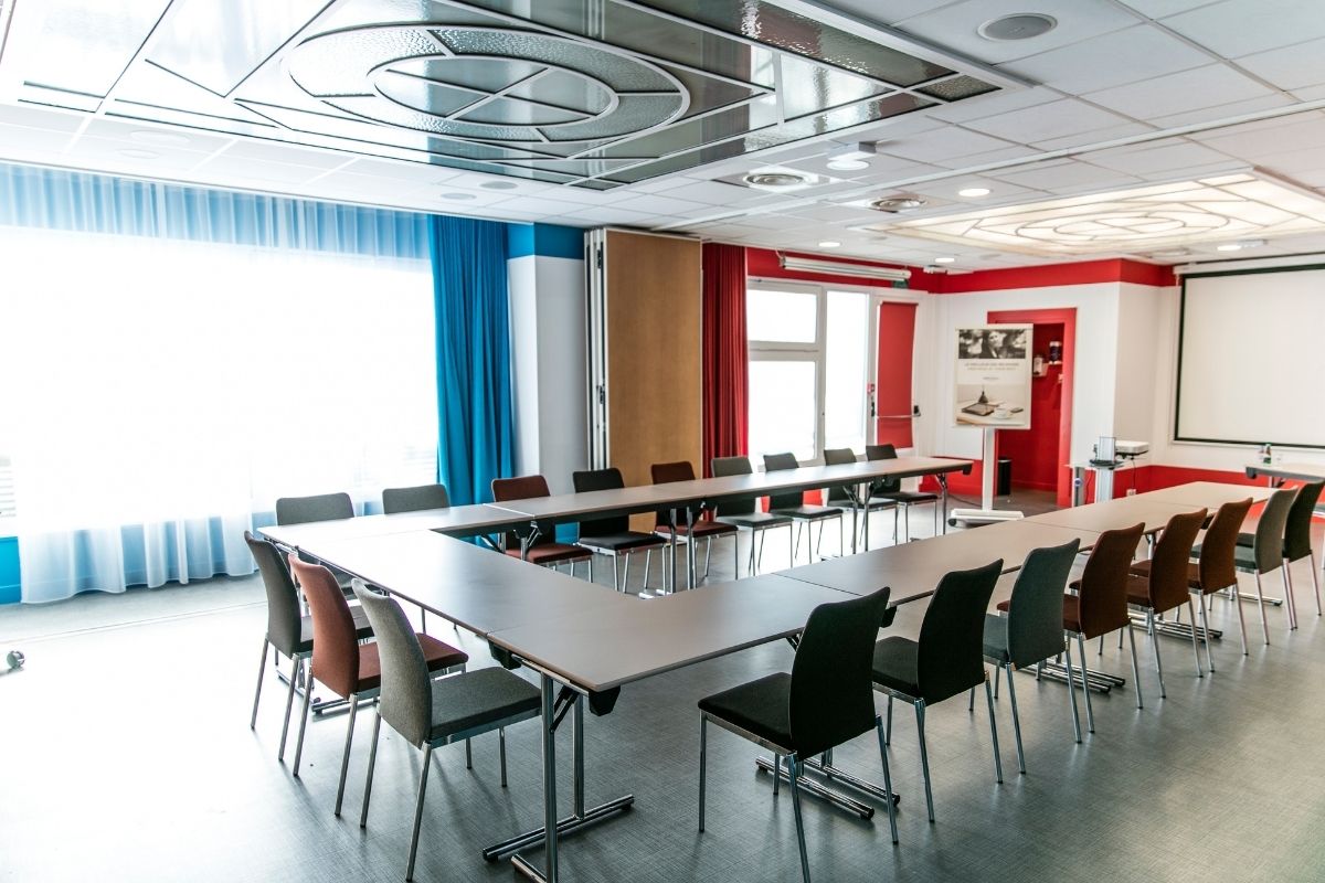 a room with a long table and chairs