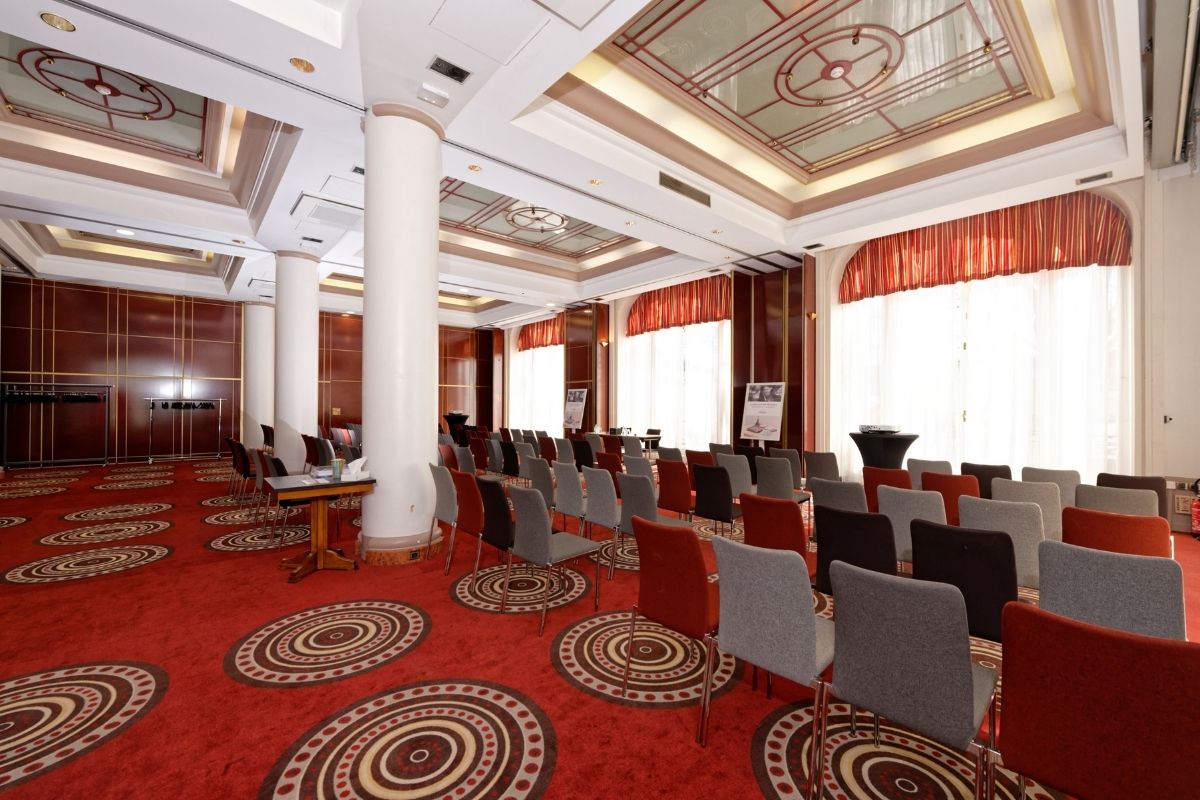 a room with red carpet and chairs