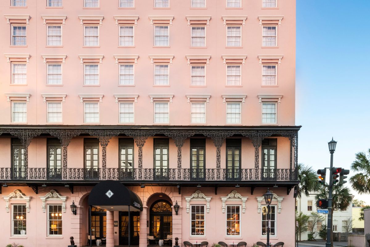 a pink building with a balcony