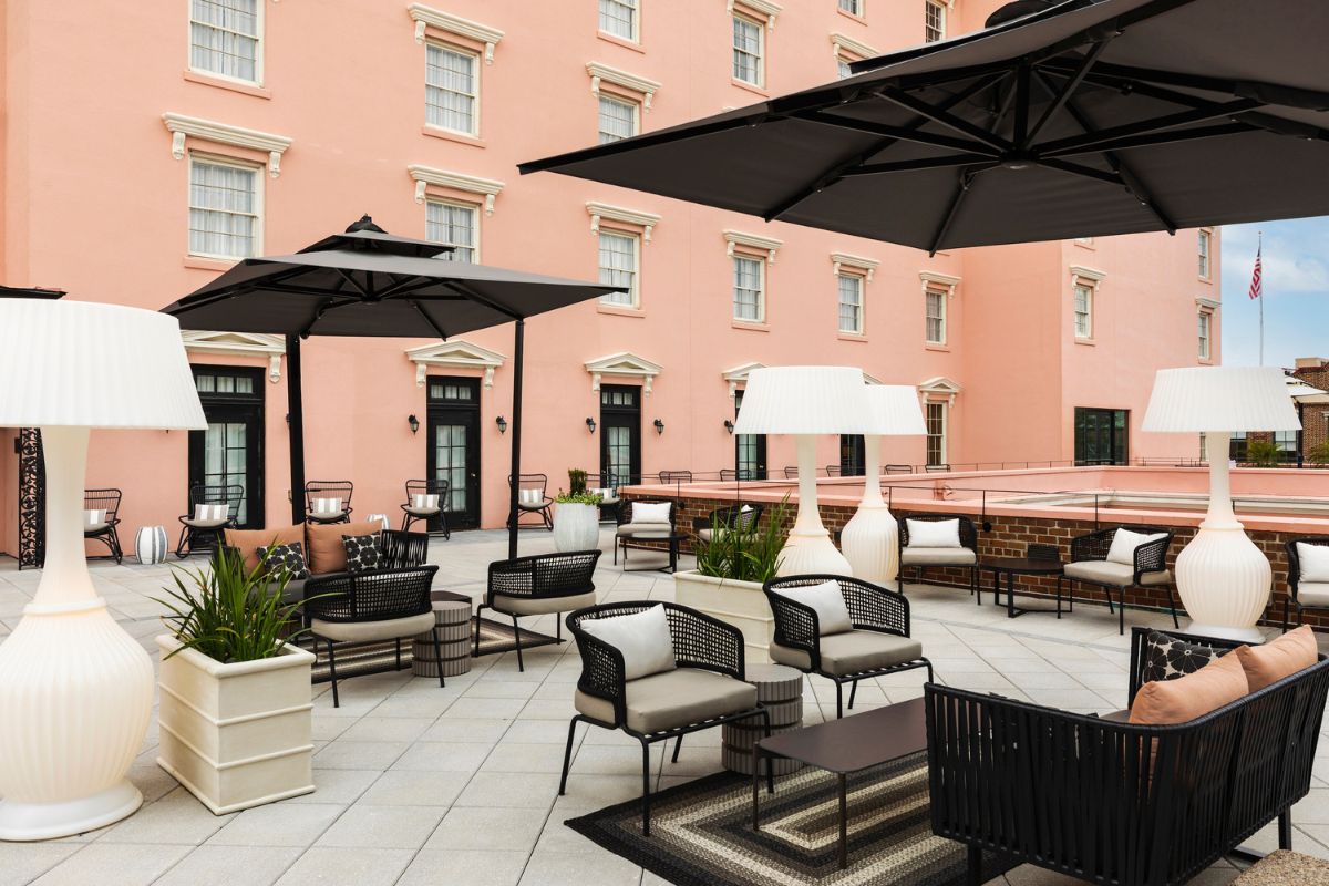 a patio with chairs and umbrellas