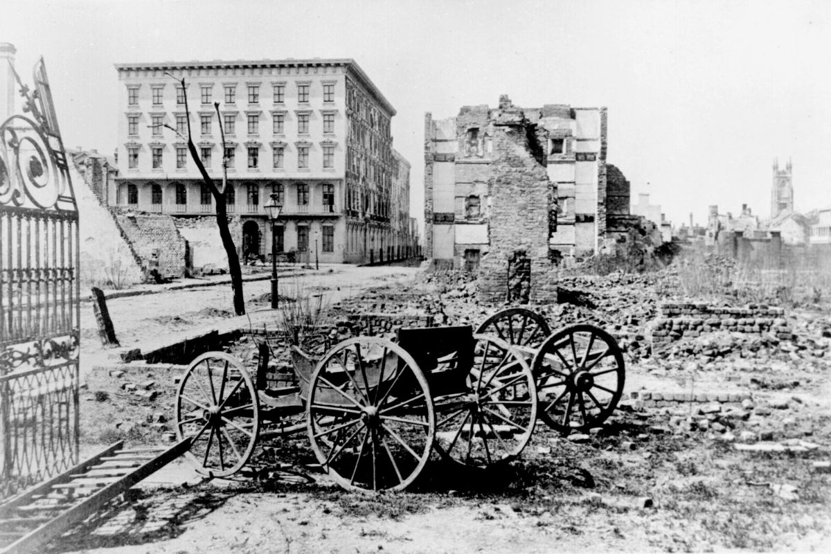 a black and white photo of a broken carriage