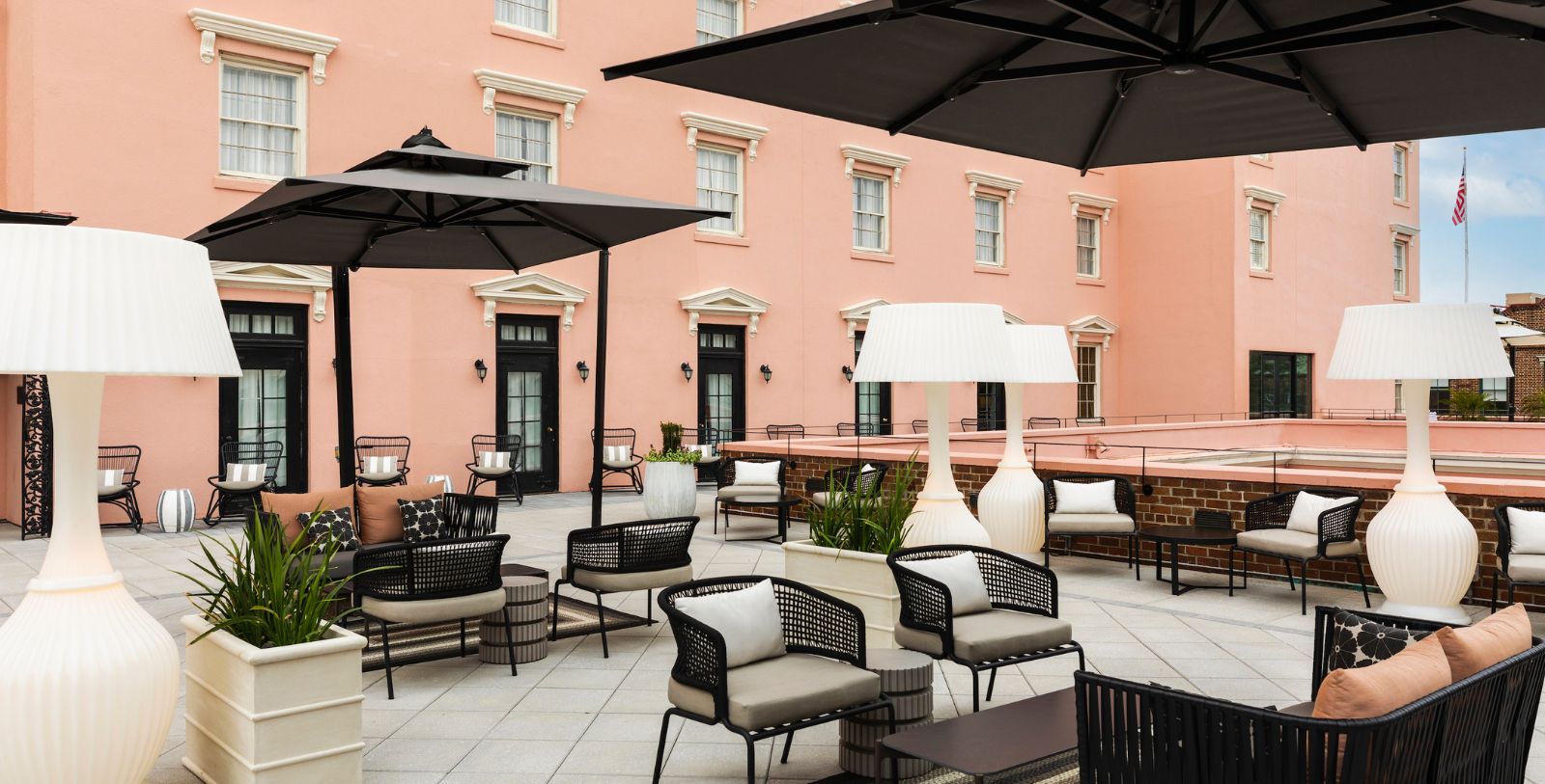 a patio area with chairs and umbrellas