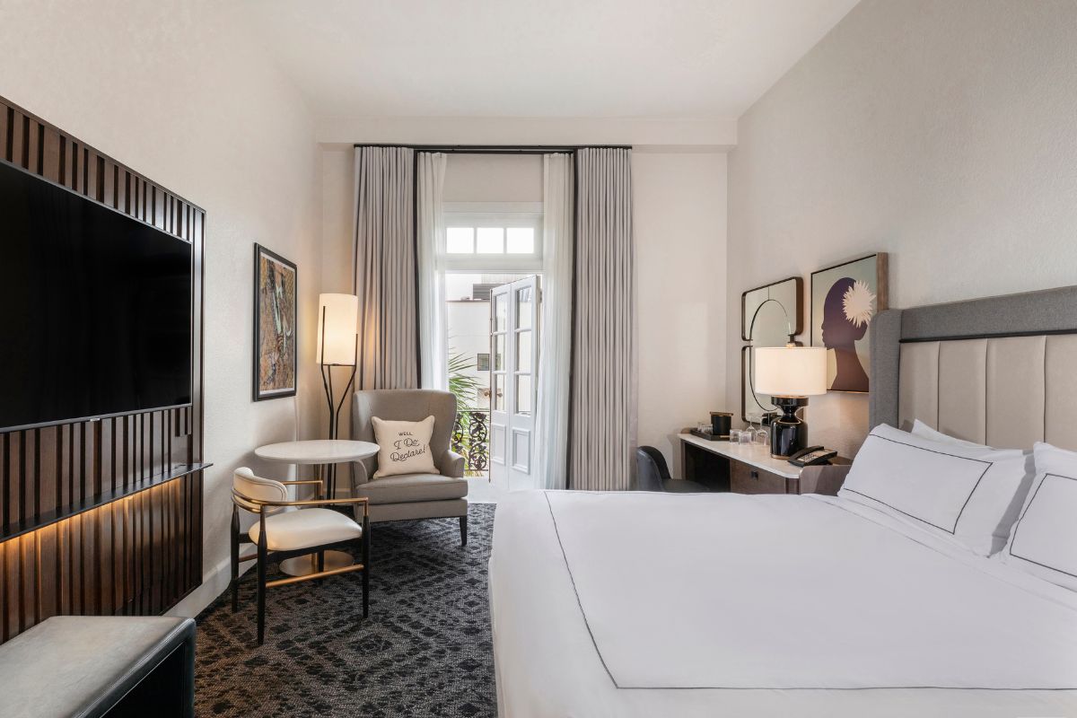 a room with a bed and a television