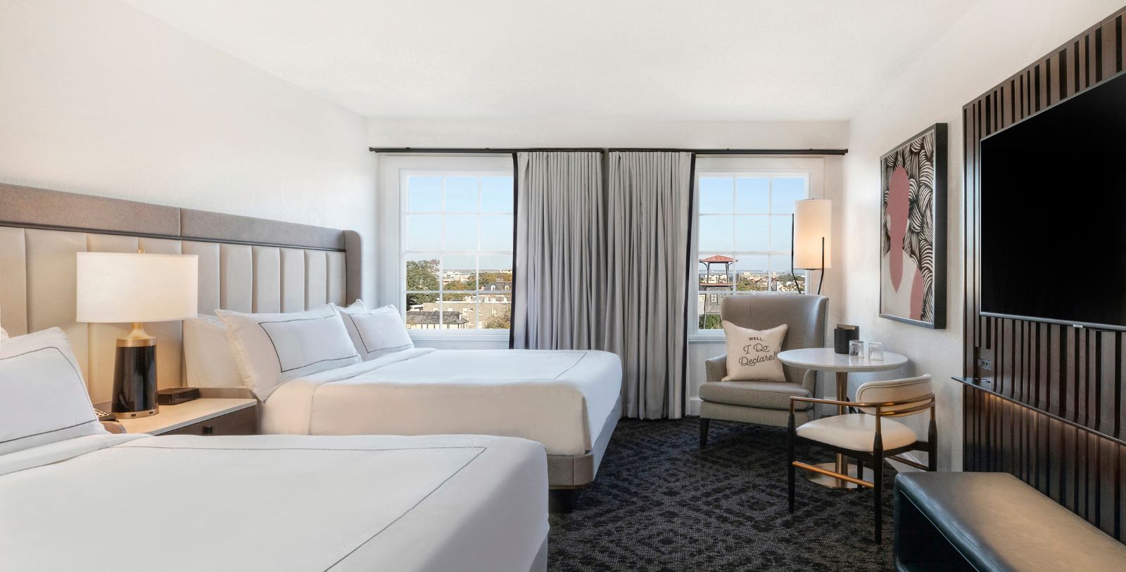 a room with two beds and a chair