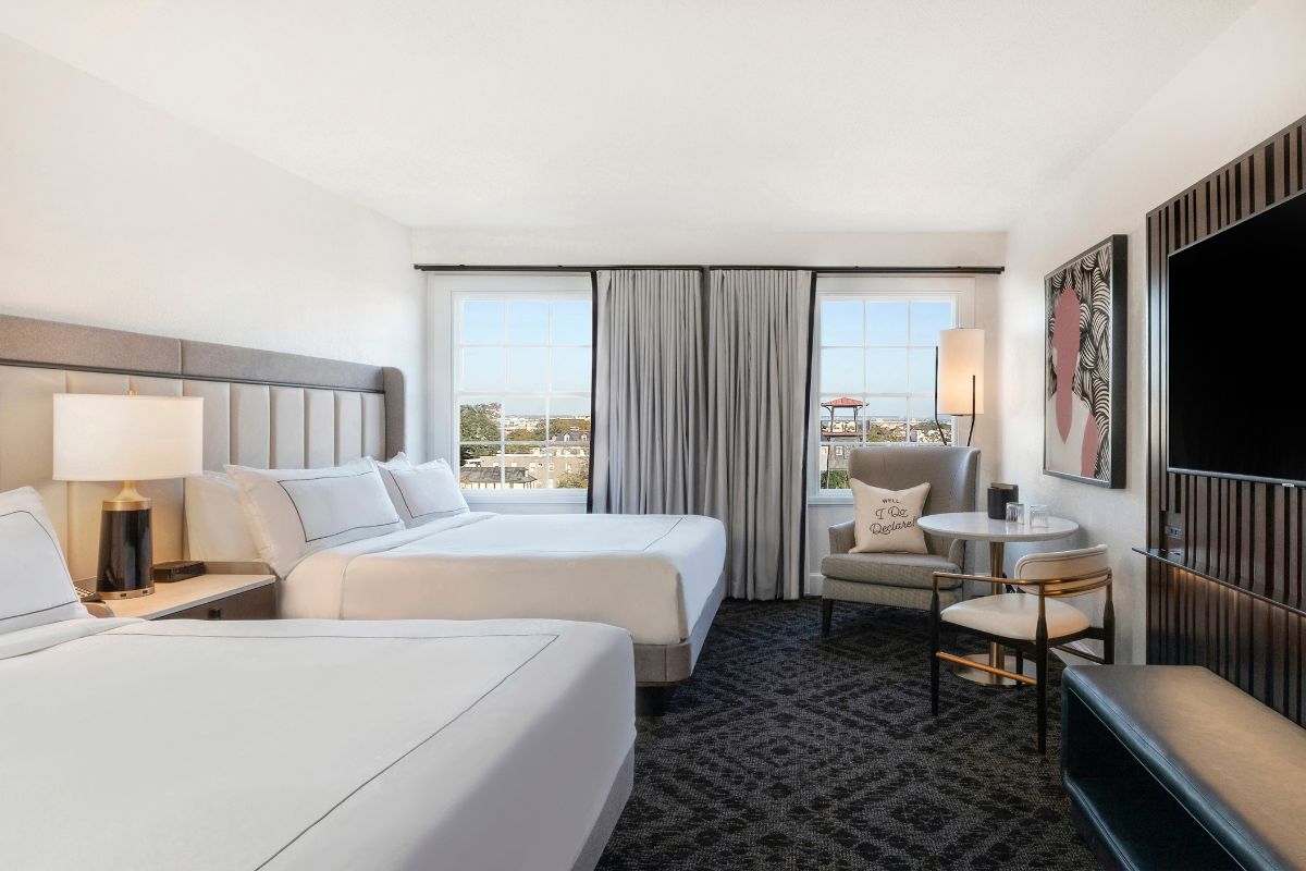 a room with two beds and a television