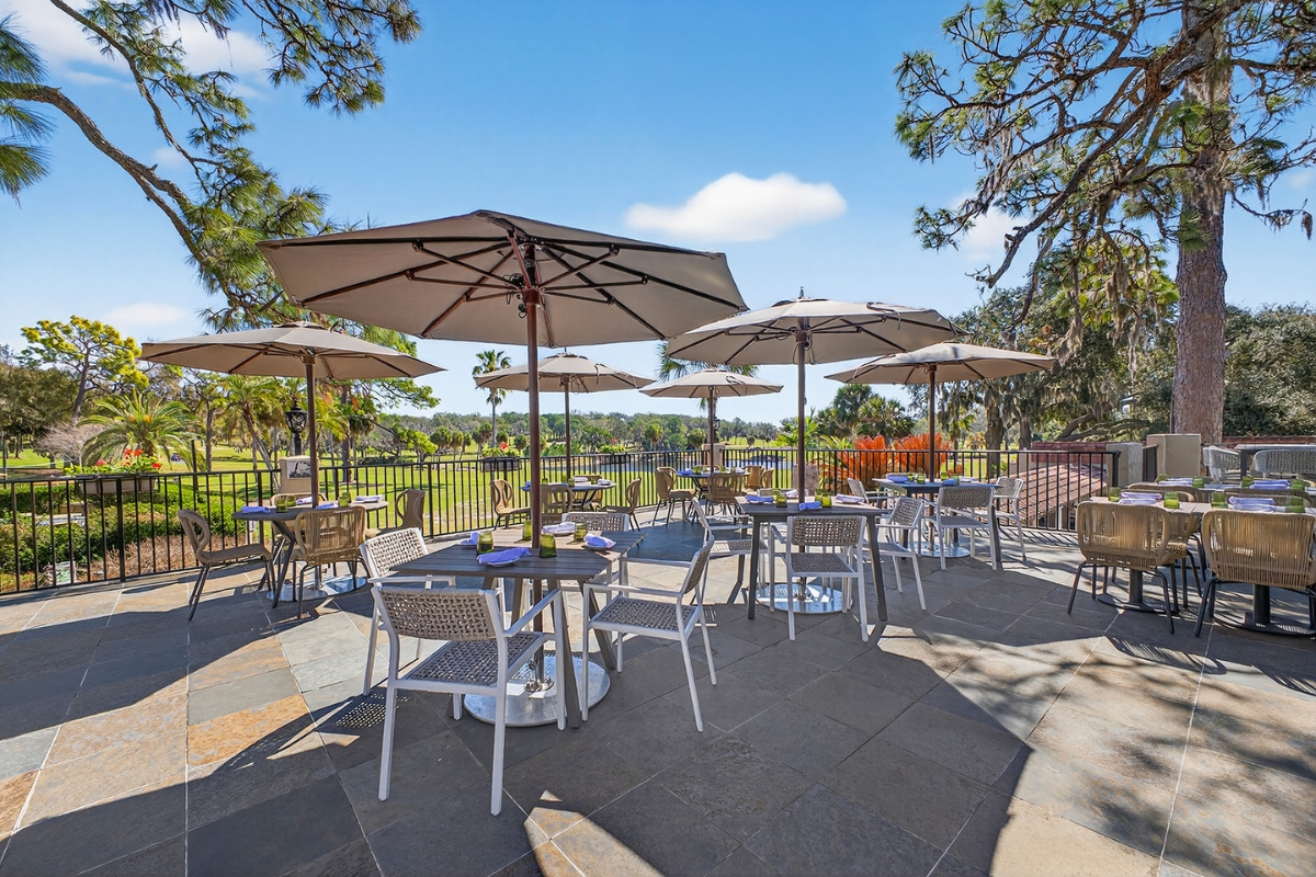 a patio with tables and umbrellas