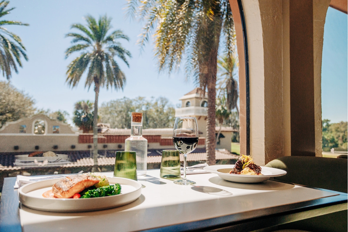 a table with food and a glass of wine